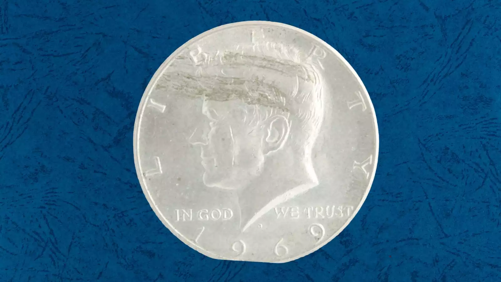 1969-D Kennedy half dollar curved clipped planchet error showing missing curved section from coin edge